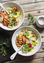 Pearl barley with seasonal garden vegetables and grilled chicken on wooden background, top view. Healthy balanced food Royalty Free Stock Photo