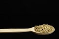 pearl barley in a wooden spoon on black background Royalty Free Stock Photo