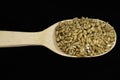 pearl barley in a wooden spoon on black background Royalty Free Stock Photo