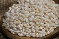 Pearl barley with wooden spoon close up surface top view background Royalty Free Stock Photo