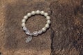 Pearl bracelet custom jewelry on the wood or stone background. Royalty Free Stock Photo