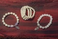 Pearl bracelet custom jewelry on the wood or stone background. Royalty Free Stock Photo