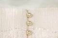 Pearl buttons on ivory wedding dress