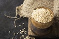 Pearl dry cereal in a vintage wooden bowl on a plain dark background for text placement and advertising. Selective focus Royalty Free Stock Photo