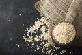 Pearl dry cereal in a vintage wooden bowl on a plain dark background for text placement and advertising. Selective focus Royalty Free Stock Photo