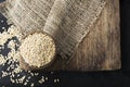 Pearl dry cereal in a vintage wooden bowl on a plain dark background for text placement and advertising. Selective focus Royalty Free Stock Photo