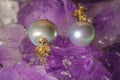 Pearl earrings on ametyst background