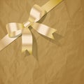 Pearl Gold ribbon on a crumpled paper brown background. Royalty Free Stock Photo