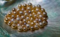 Collection of Golden Pearls on a Sea Shell Royalty Free Stock Photo