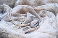 Pearl necklace and antique cameo on lace. Royalty Free Stock Photo