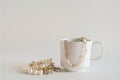 A pearl necklace and bracelet rest in a white teacup Royalty Free Stock Photo