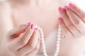 Pearl necklace in female hands, close up view Royalty Free Stock Photo