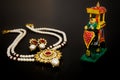 Pearl necklace and golden pendant with pair of earrings, elephant mahout rider