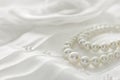 Pearl necklace on lace background. Royalty Free Stock Photo