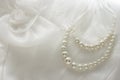 Pearl necklace on lace background. Royalty Free Stock Photo