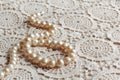 Pearl necklace on lace fabric Royalty Free Stock Photo