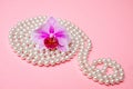 Pearl necklace and purple orchid Royalty Free Stock Photo