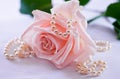 Pearl necklace and soft pink rose