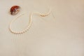 Pearl necklace on white fine sand with sea shell. Luxury resort, ocean or sea wedding concept Royalty Free Stock Photo