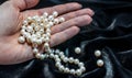 Pearl necklace on the woman's hand Royalty Free Stock Photo