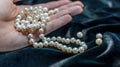 Pearl necklace on the woman's hand Royalty Free Stock Photo