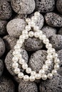 Pearl necklaces on grey stones