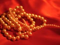 Pearl necklace jewelry on red satin background for valentines day Royalty Free Stock Photo