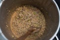 Pearl Porridge in a Saucepan, Close up, in Metallic Saucepan with wooden Spoon. Top view. Royalty Free Stock Photo