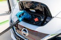 Pearland, Texas - March 21, 2018: New 2018 Nissan Leaf electric car plugged in to charge battery at the EVgo charging station