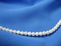 Pearls on background the blue fabric