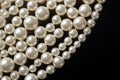 Pearls background. Pearl beads, string of pearls on black background closeup. Pearl texture Royalty Free Stock Photo