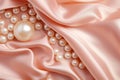 Pearls background. Pile of white natural pearls on pink silk closeup. Pearl on smooth elegant silky fabric texture Royalty Free Stock Photo