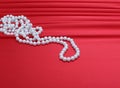 Pearls beads on red silk Royalty Free Stock Photo