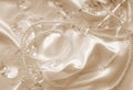 Pearls and nacreous beeds on silk as wedding background. In Sepi Royalty Free Stock Photo