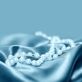 Pearls on a silk fabric background