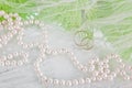 Pearls, wedding rings and bouquet Royalty Free Stock Photo