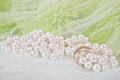 Pearls, wedding rings and bouquet Royalty Free Stock Photo