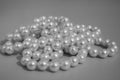 Pearls of white color close-up. Black and white photo. Pendants on the neck. Close up natural white pearl necklace on