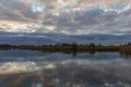 The pearly sky colors the broken clouds beautifully at lake Zoetermeerse plas in Zoetermeer, Netherlands