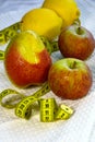 Pears, apples, lemons and a centimeter tape close-up. Diet for weight loss. Healthy fruits Royalty Free Stock Photo