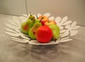 Pears and apples on the plate as decoration of the kitchen table