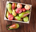 Pears and apples in wooden box on table Royalty Free Stock Photo