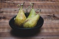 Pears in ceramic bowl over wooden background. Royalty Free Stock Photo