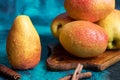 Pears on a dark background. Fresh, ripe fruits on a blue plate and in a box. Healthy eating