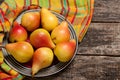 Pears on the dish and cloth on the old wood backing