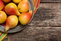 Pears on the dish and cloth on the old wood backing