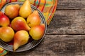 Pears on the dish and cloth on the old wood backing