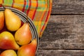 Pears on the dish and cloth on the old wood backing