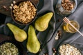 Pears, honey and homemade granola on table