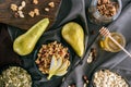 Pears, honey and homemade granola on tabletop